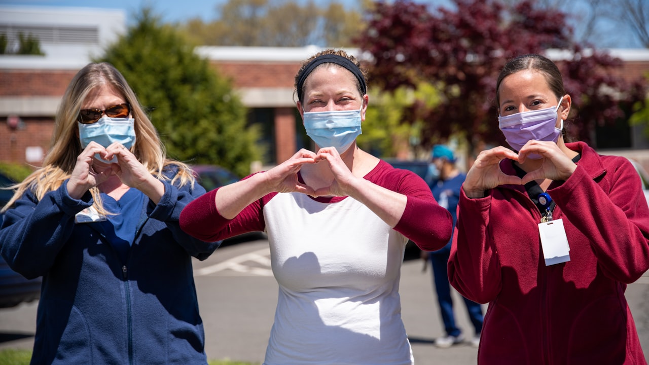 Care team standing together outside a clinic